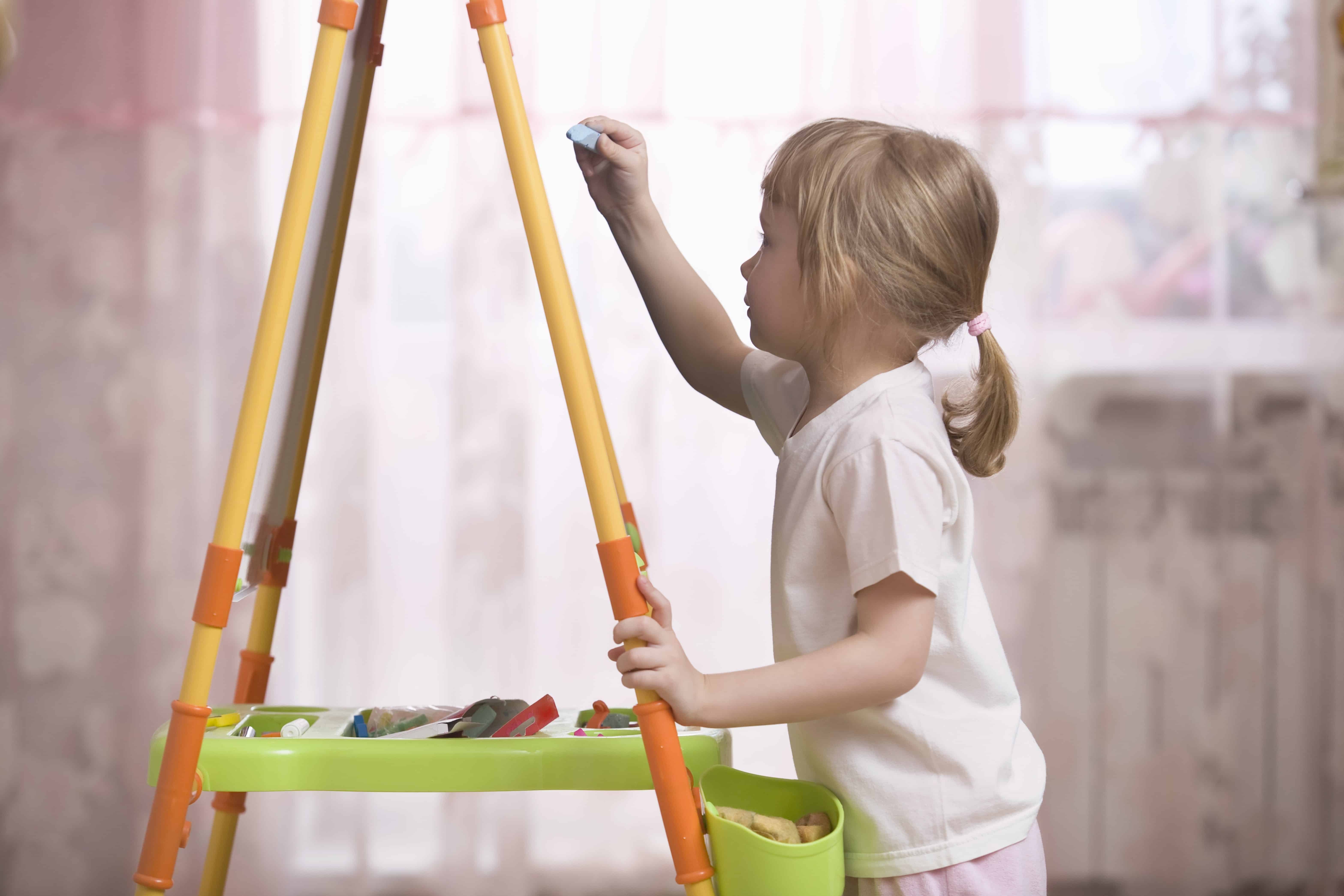 Child drawing on blackboard