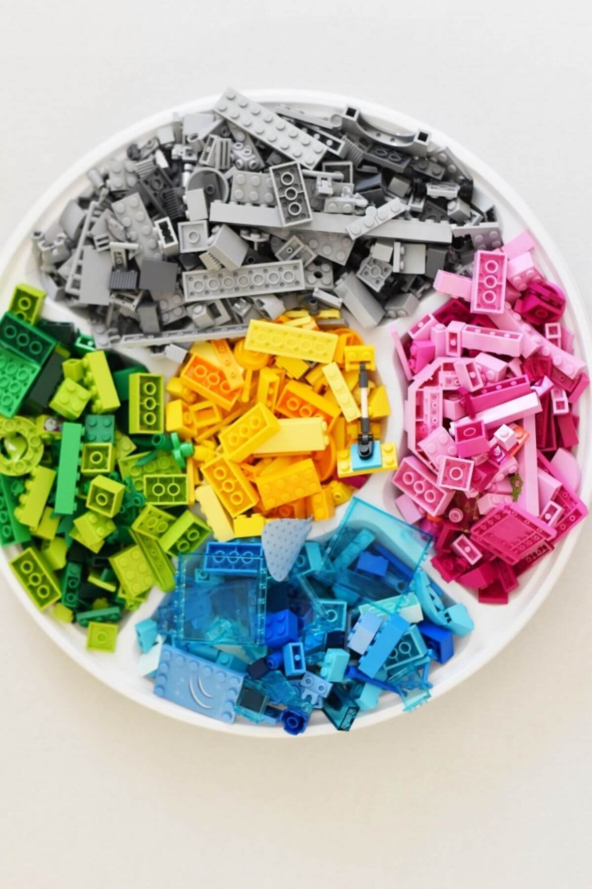 lego pieces sorted by colour in a tray