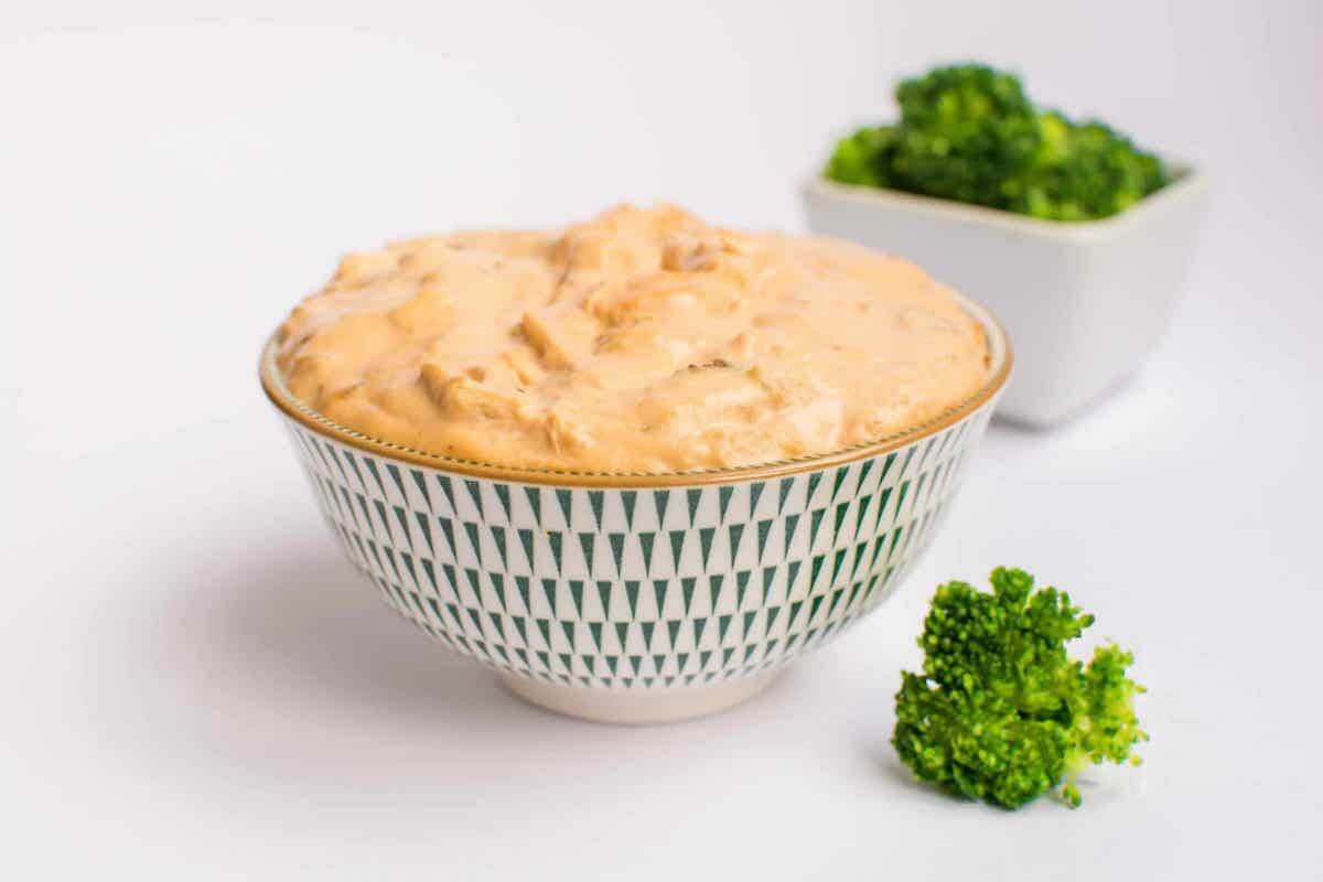 chicken buffalo dip in a bowl with garnish