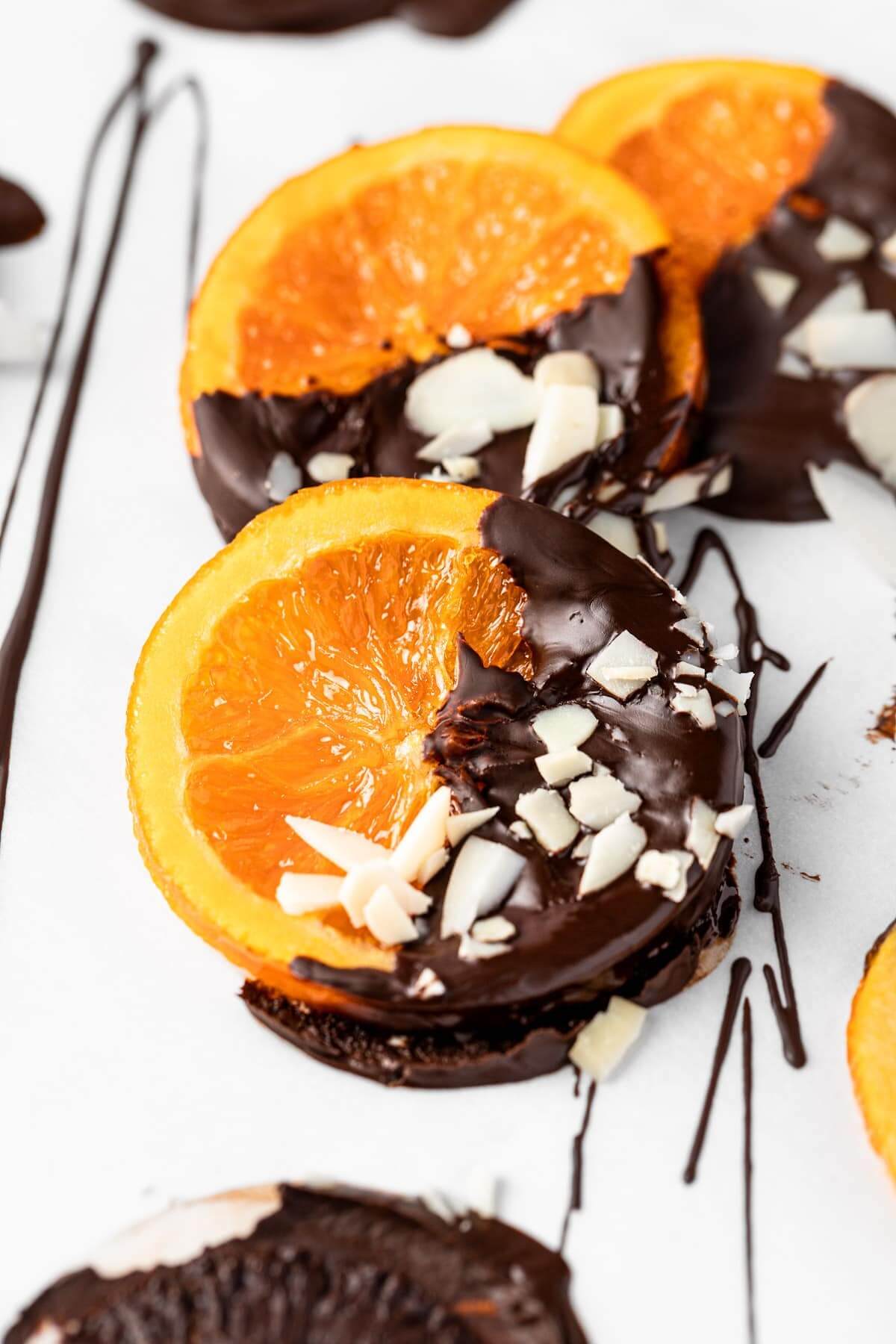 chocolate dipped orange slices on a table