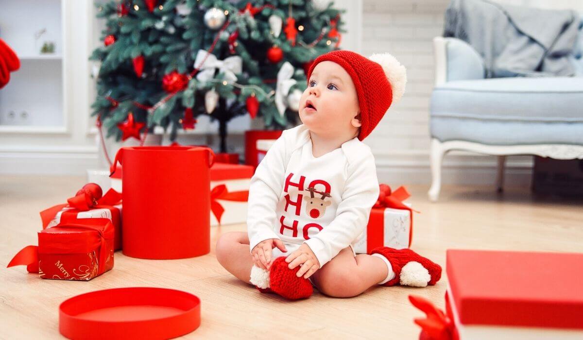 toddler with christmas gifts