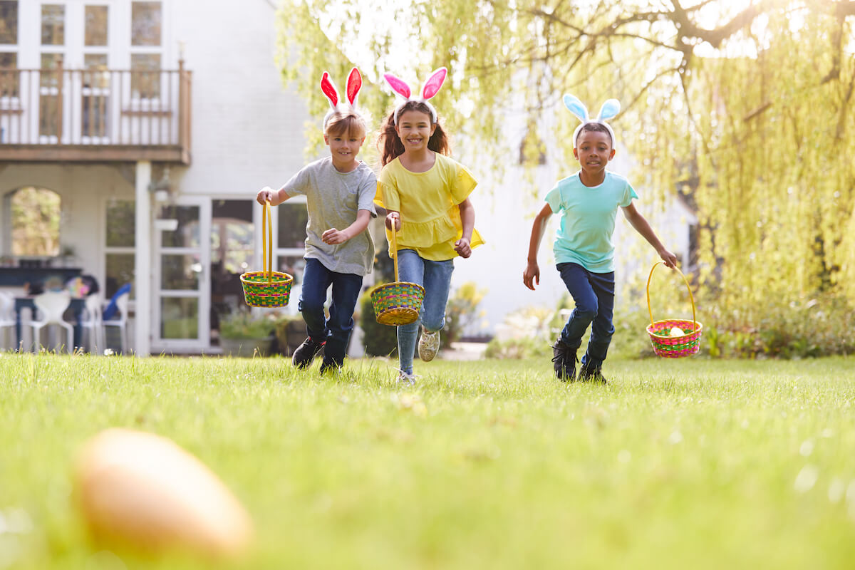 kids getting ready for an easter egg hunt in the backyard