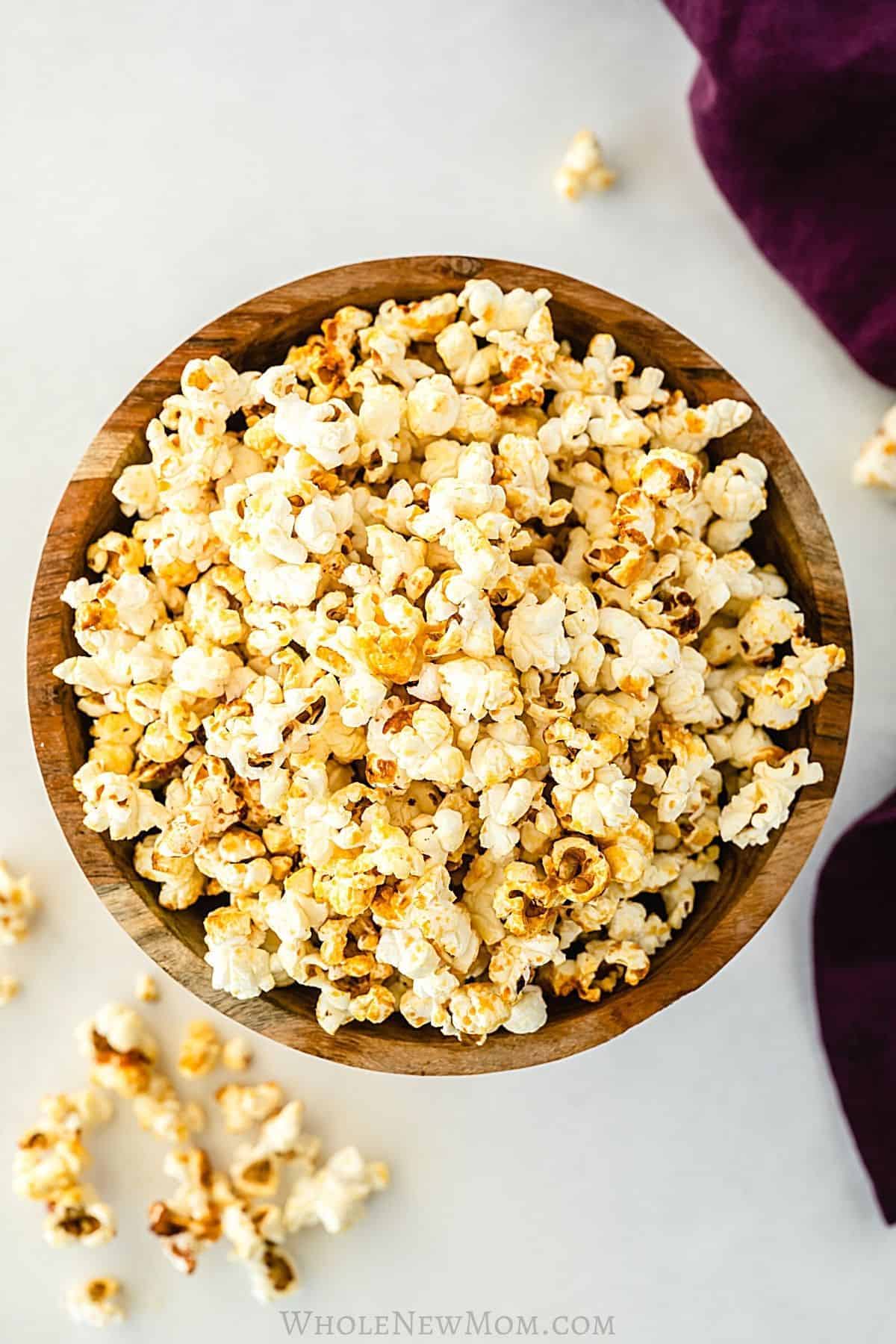 healthy kettle popcorn spillig out of a brown bowl