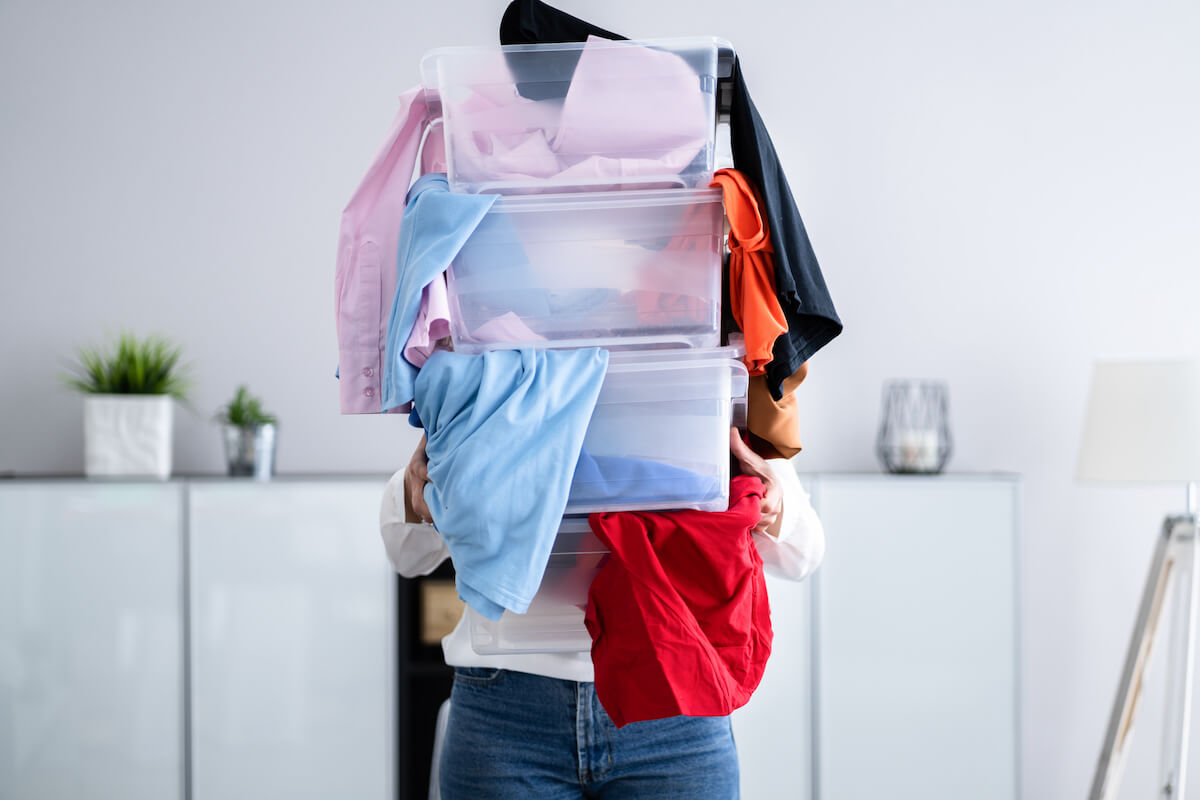 woman with tubs full of clothes