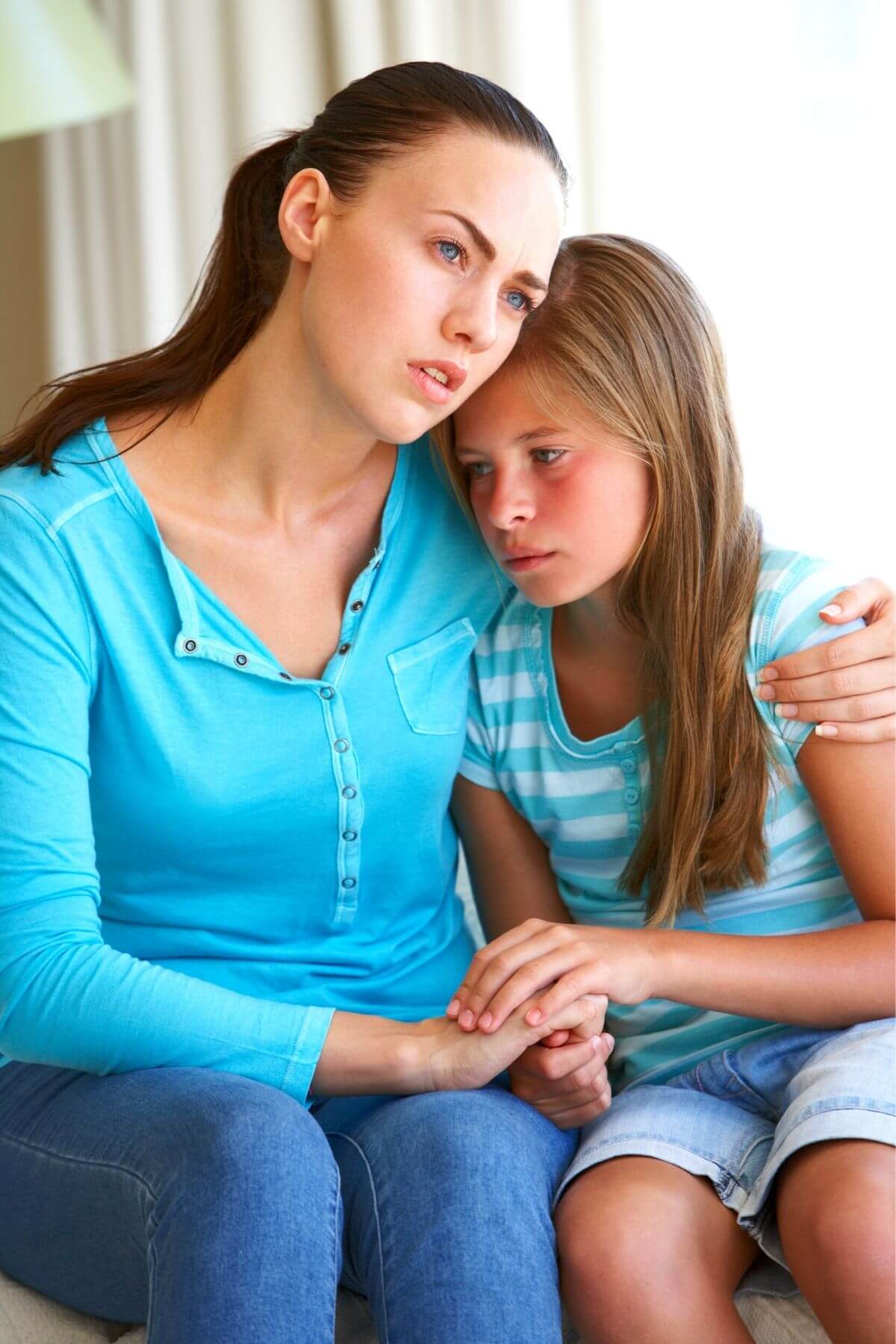 Mother comforting her upset daughter