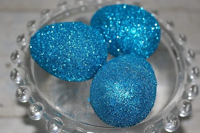 blue glitter easter eggs in glass dish