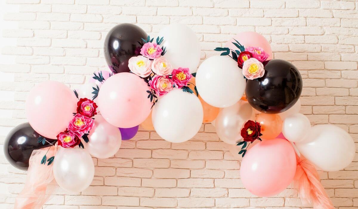 birthday party balloon arch pink white and black