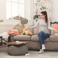 woman disgusted with messy living room