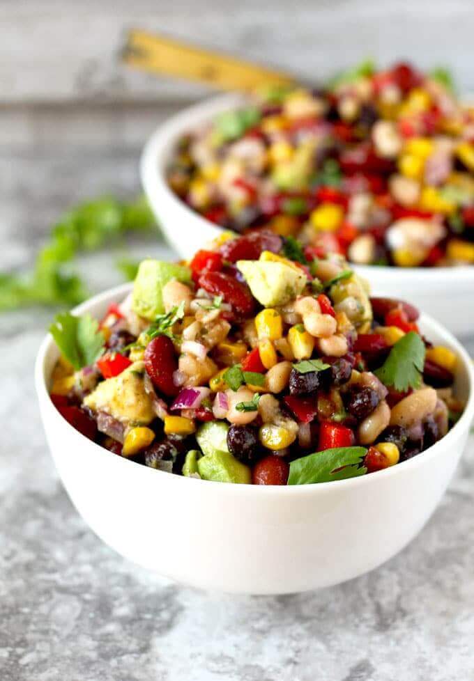 mexican three bean salad stacked high in a bowl