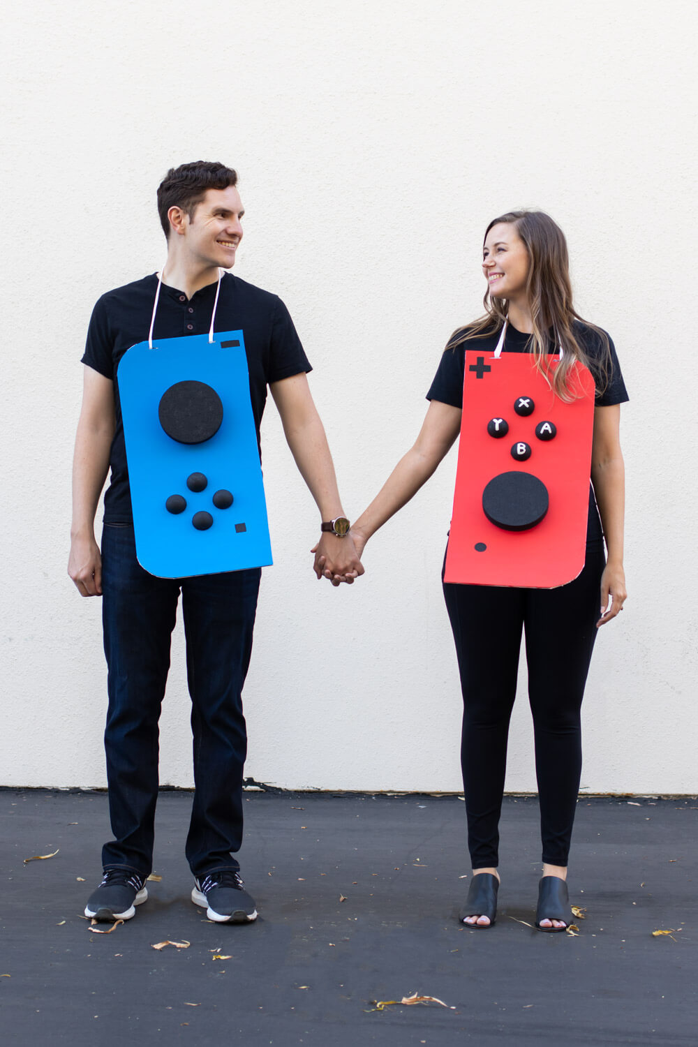 man and woman dressed as nintendo switch control pads for halloween