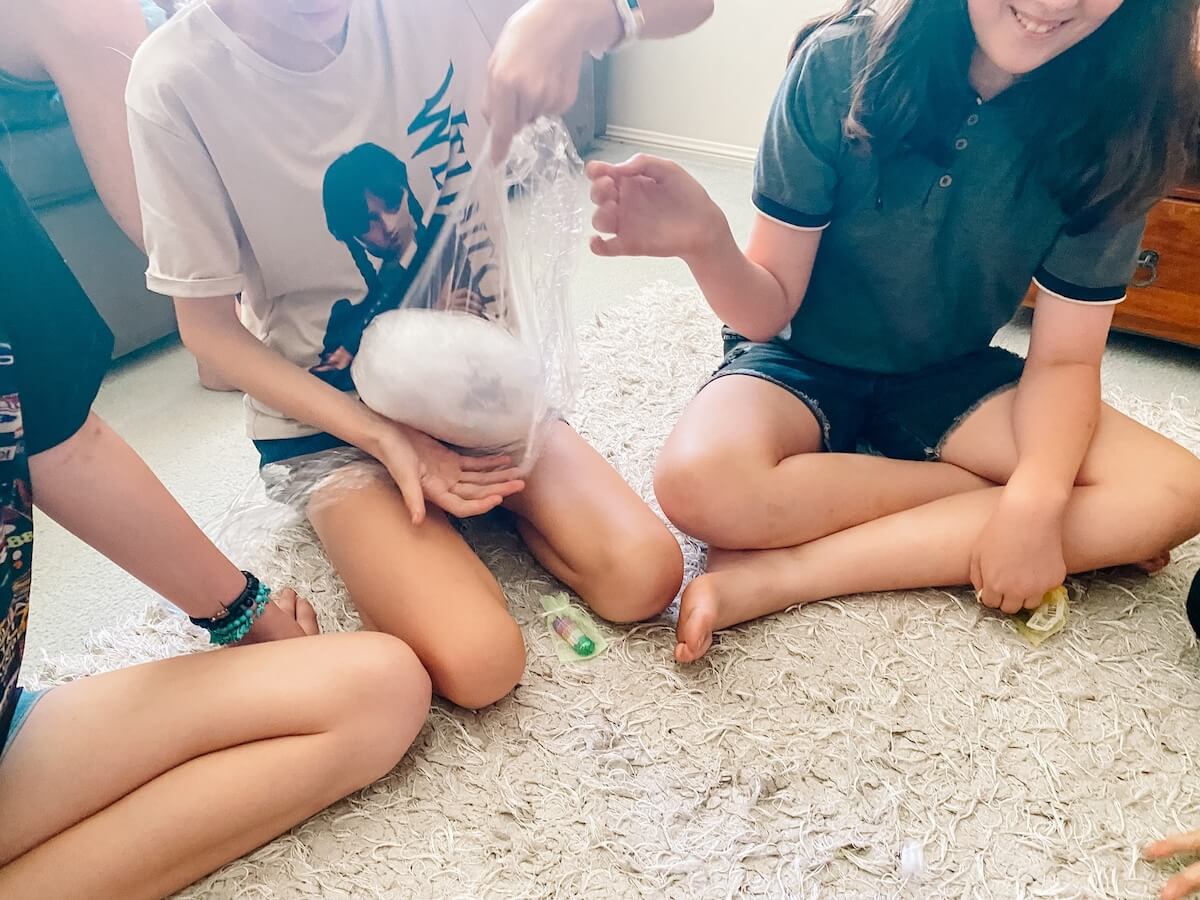 kids playing the saran wrap ball game at a birthday party.