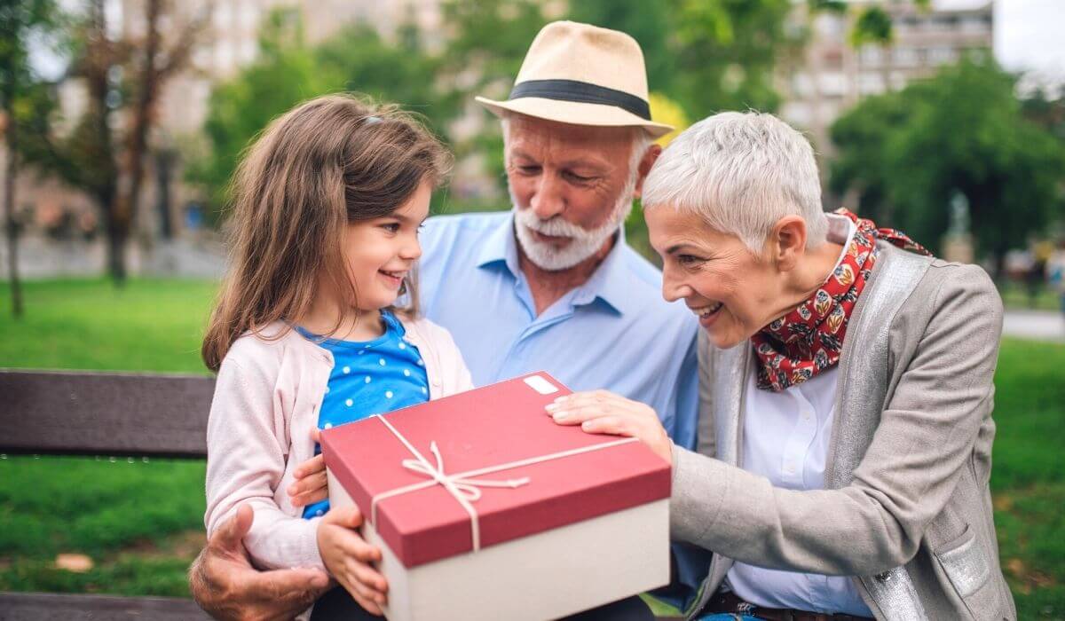 child giving grandparents a large gift