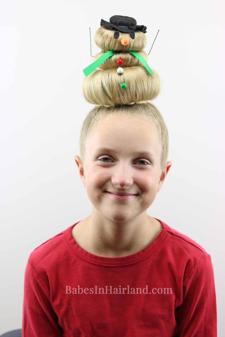 snowman buns with three stacked buns on top of the head and snowman decorations. 