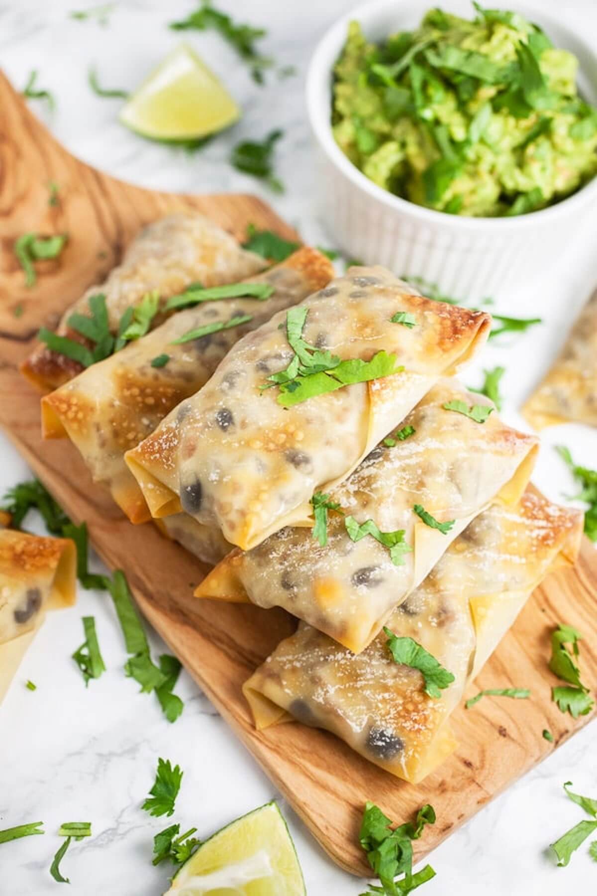 southwest baked egg rolls on wooden board