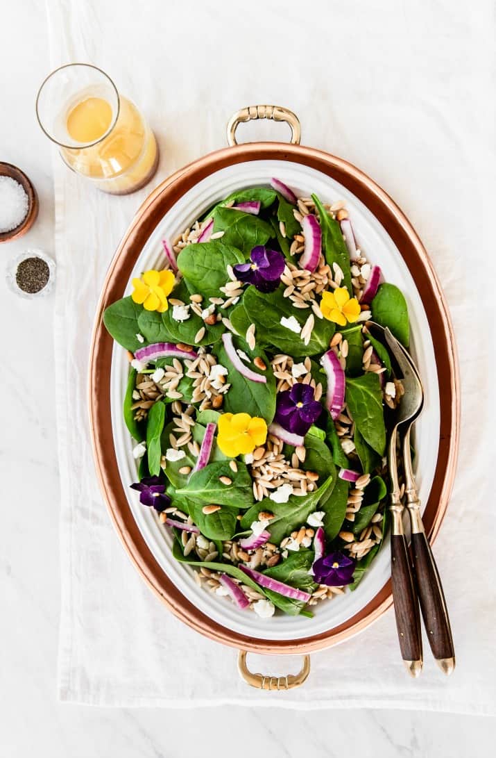 spinach salad with orzo in serving dish