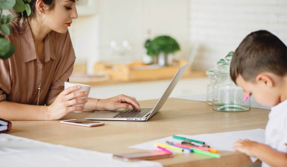 woman working on her laptop in the kitchen