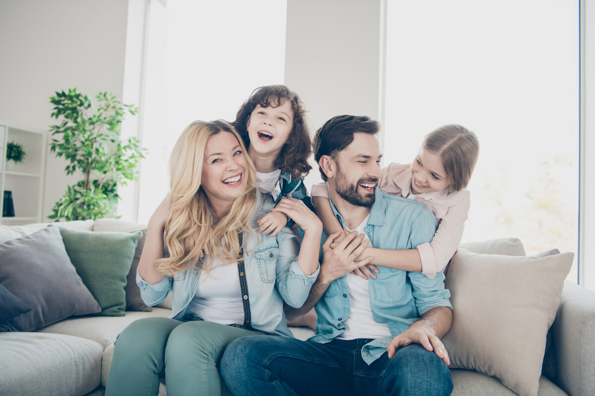 family hugging on the couch