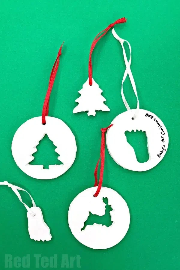 handmade cookie cutter ornaments on a green background.