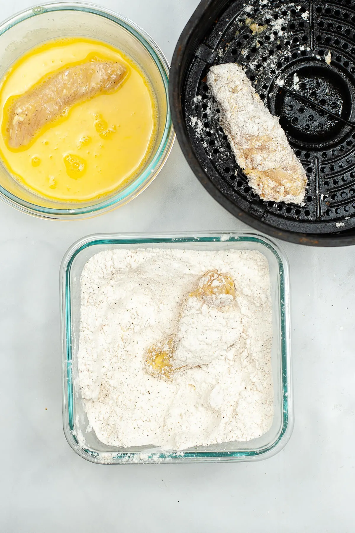 rolling chicken breast strips in coating for air fryer