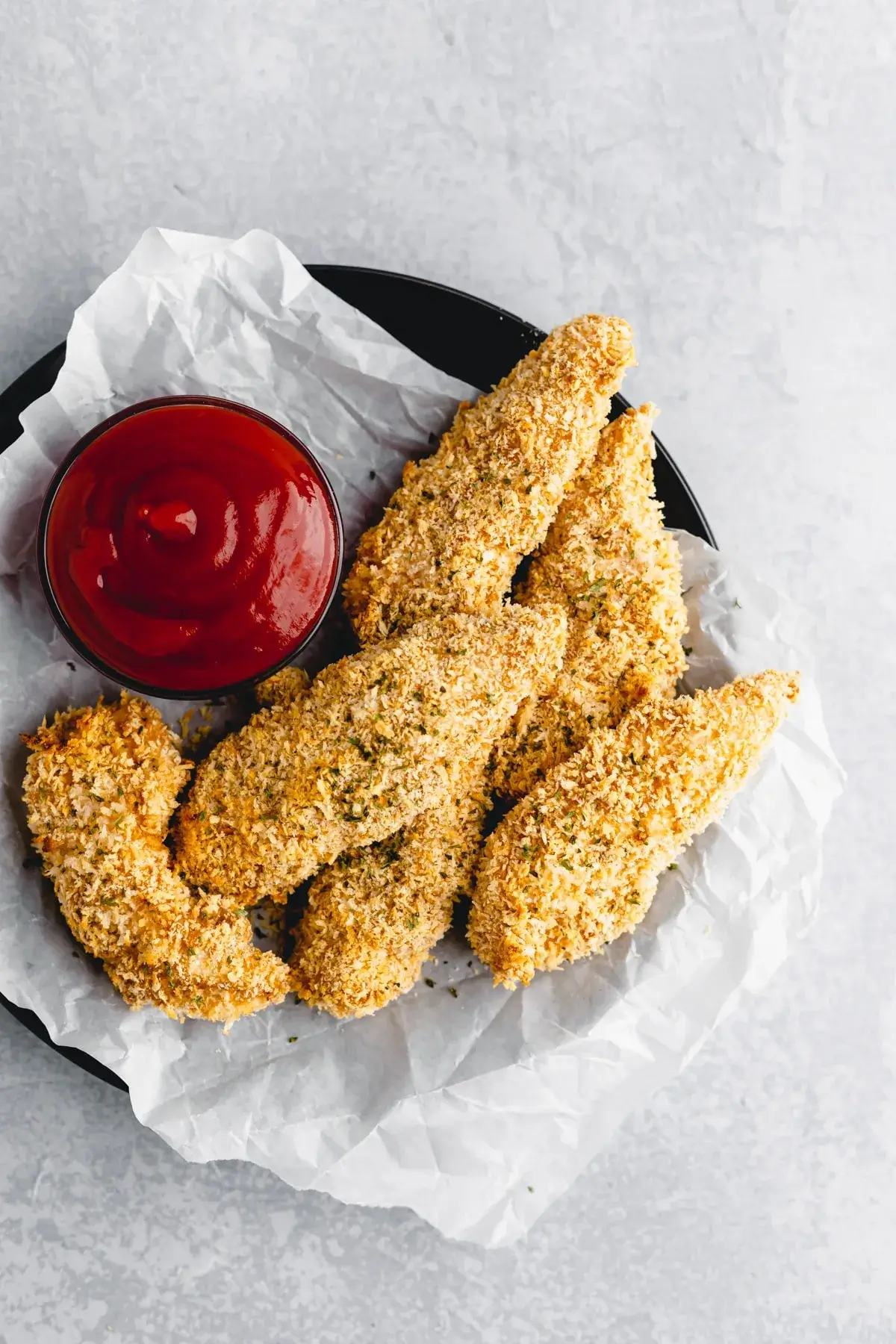 baked chicken tenders on a plate with sauce