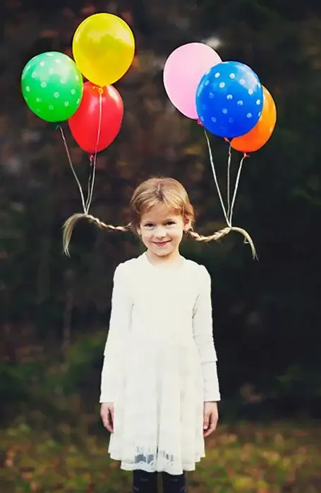 helium balloon hair with balloons holding up braids.