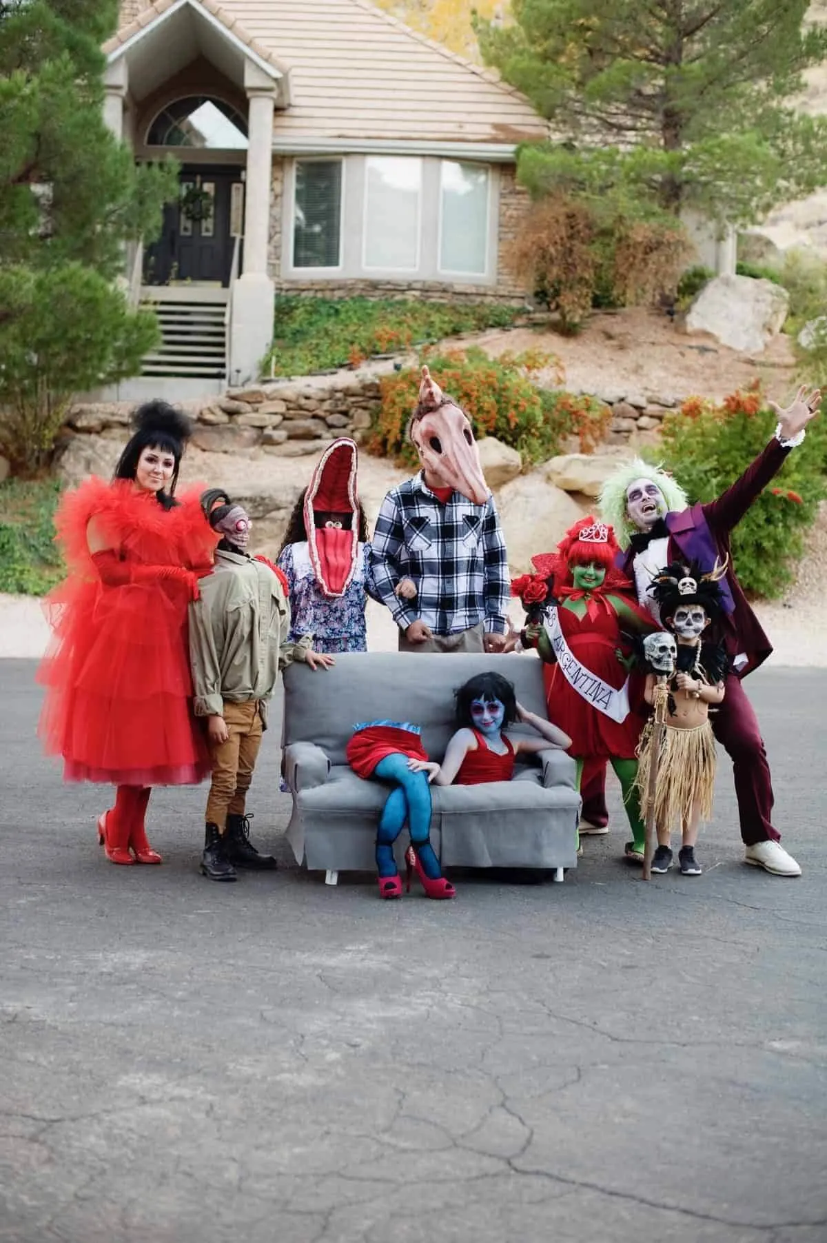 family beetlejuice costume posting in the middle of a street.