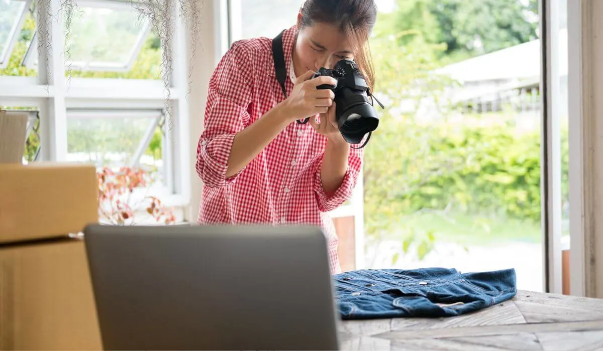 woman taking photograph of shirt to sell