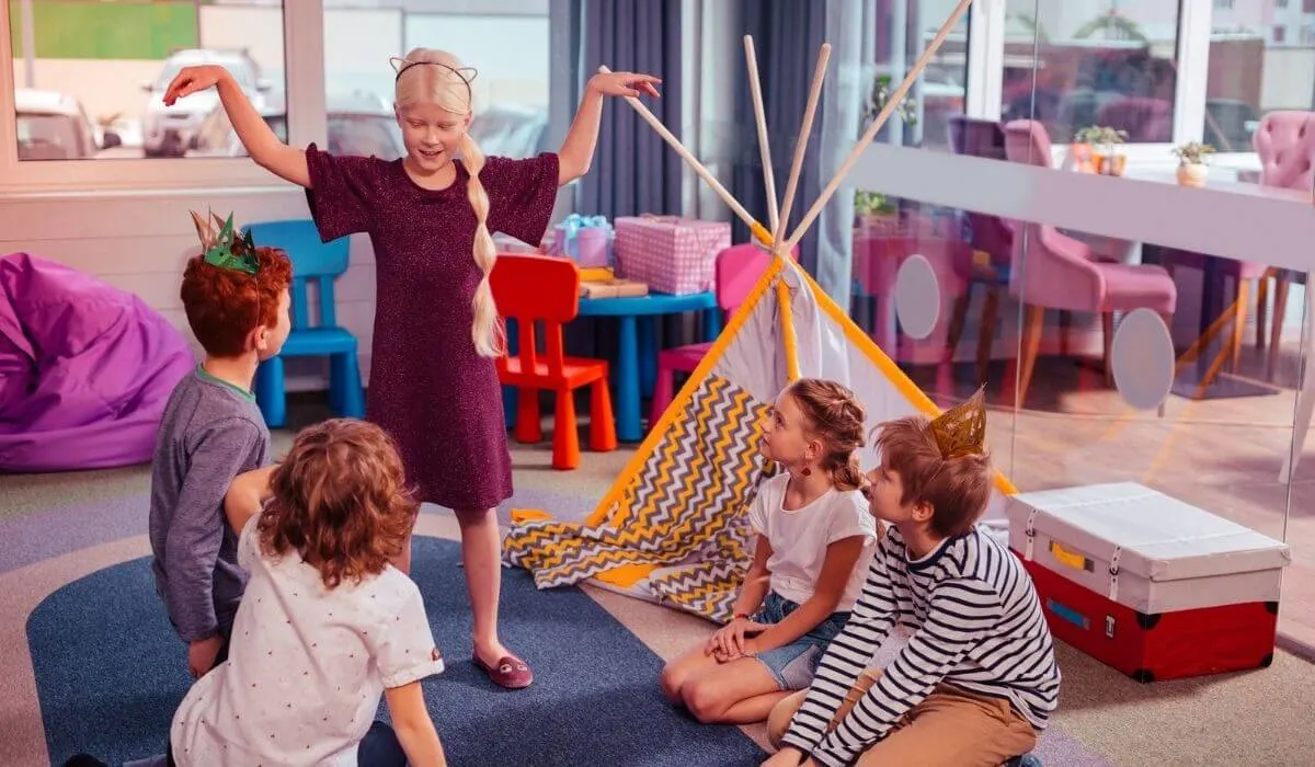 a group of kids playing charades at an indoor party venue