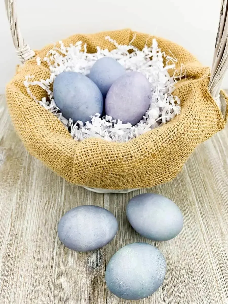 easter eggs dyed with blueberries in a basket