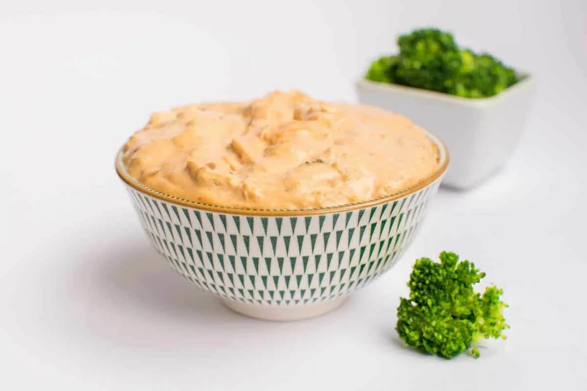 chicken buffalo dip in a bowl with garnish