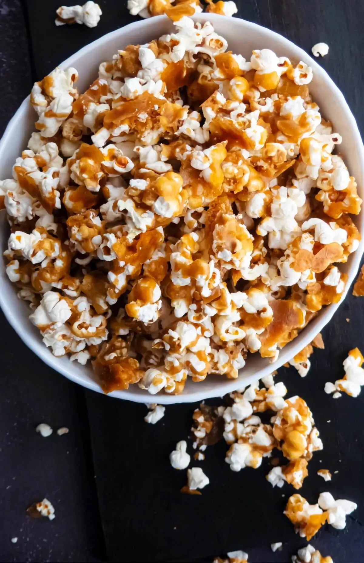 caramel popcorn overflowing from a bowl