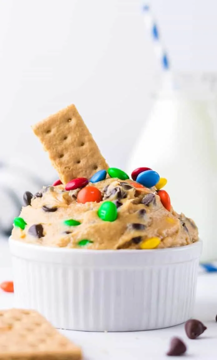 chocolate chip cookie dough diip in white bowl with graham cracker