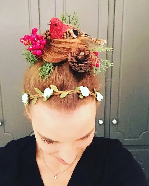 birdsnest hairstyle with pinecone, bird, berries and foliage on a woman.
