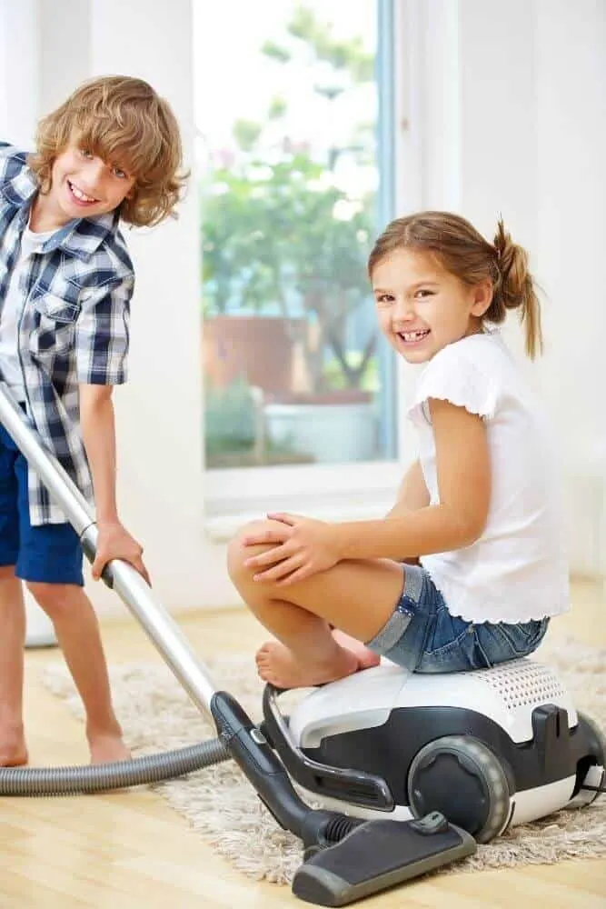 Brother and sister vacuuming