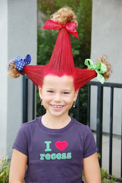 tall hair in 3 cones sprayed red with colourd hairspray and bows at the ends.