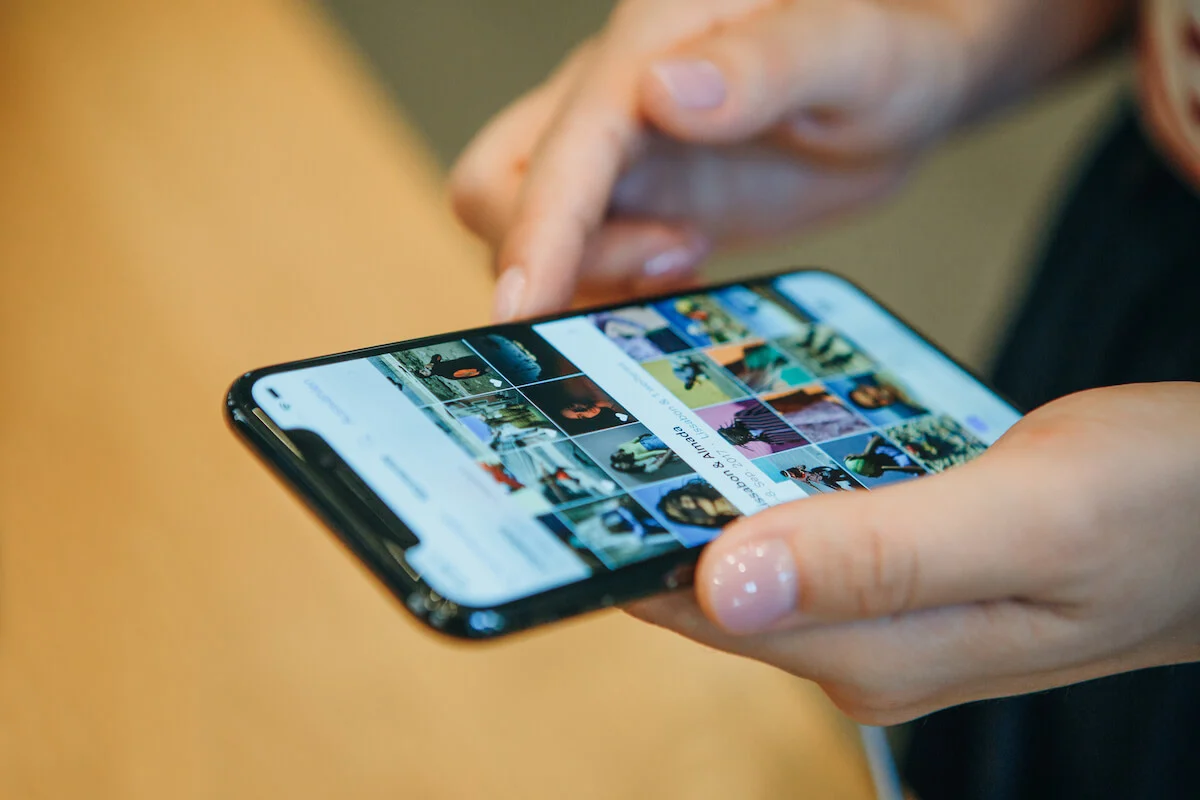 woman sorting through her phone photo gallery