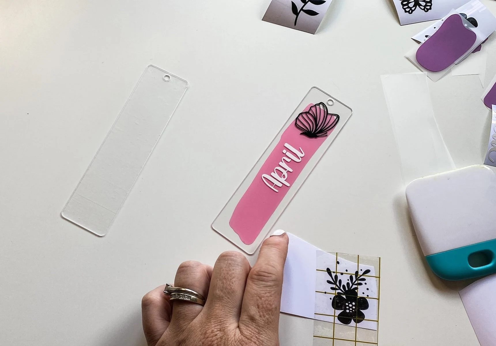 applying vinyl designs onto acrylic bookmarks.