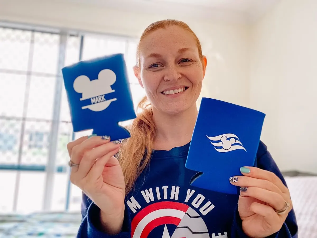 Holly holding 2 blue DIY personalised can coolers.