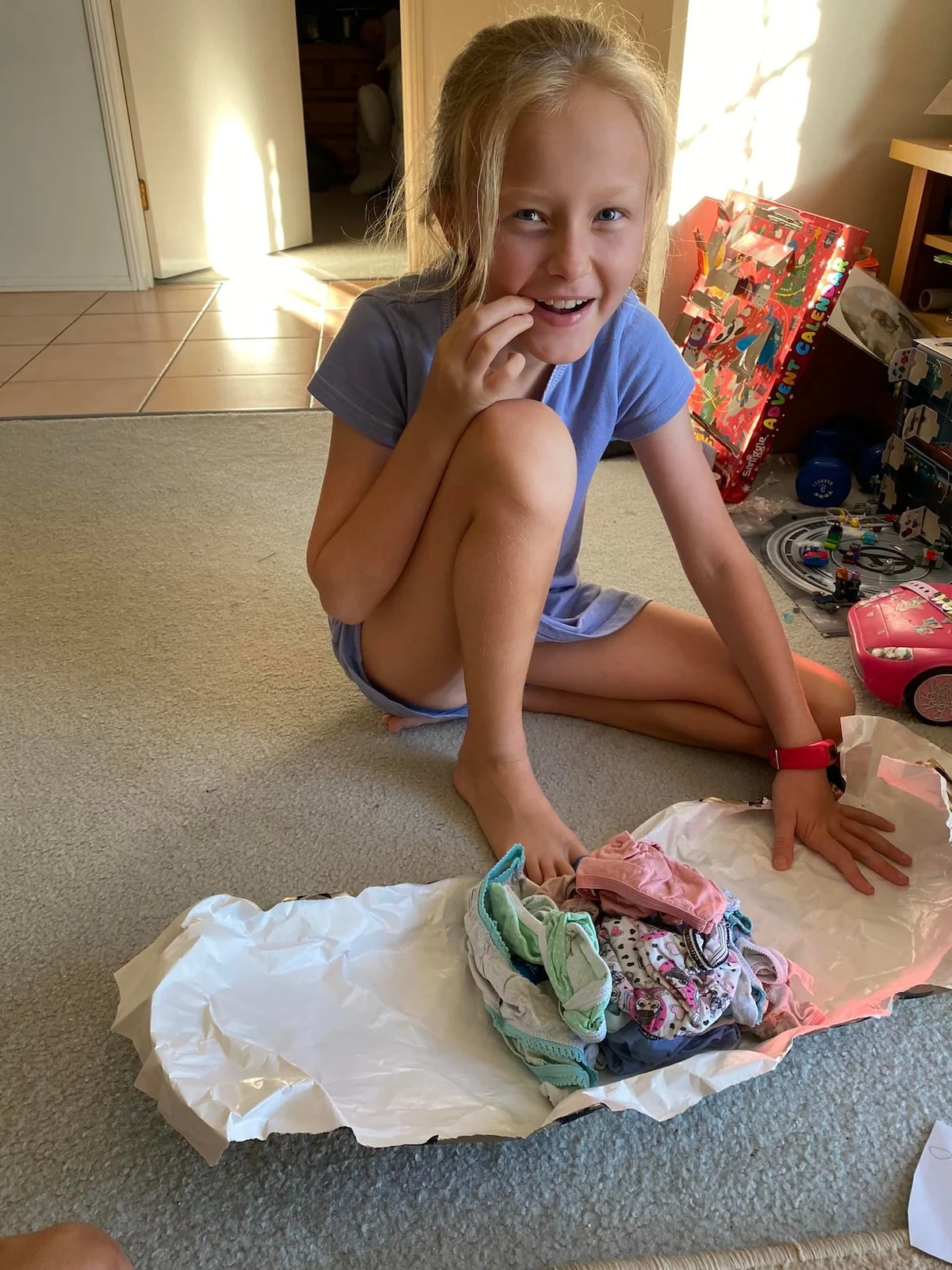 little girl unwrapping prank gift from her elf.