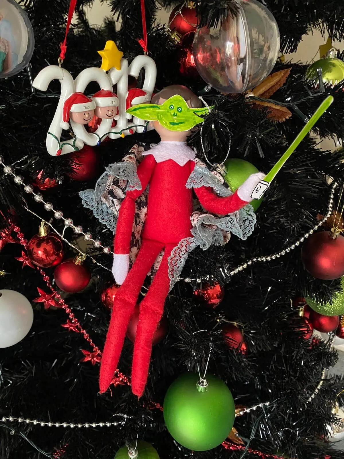 yoda elf on the shelf with light saber