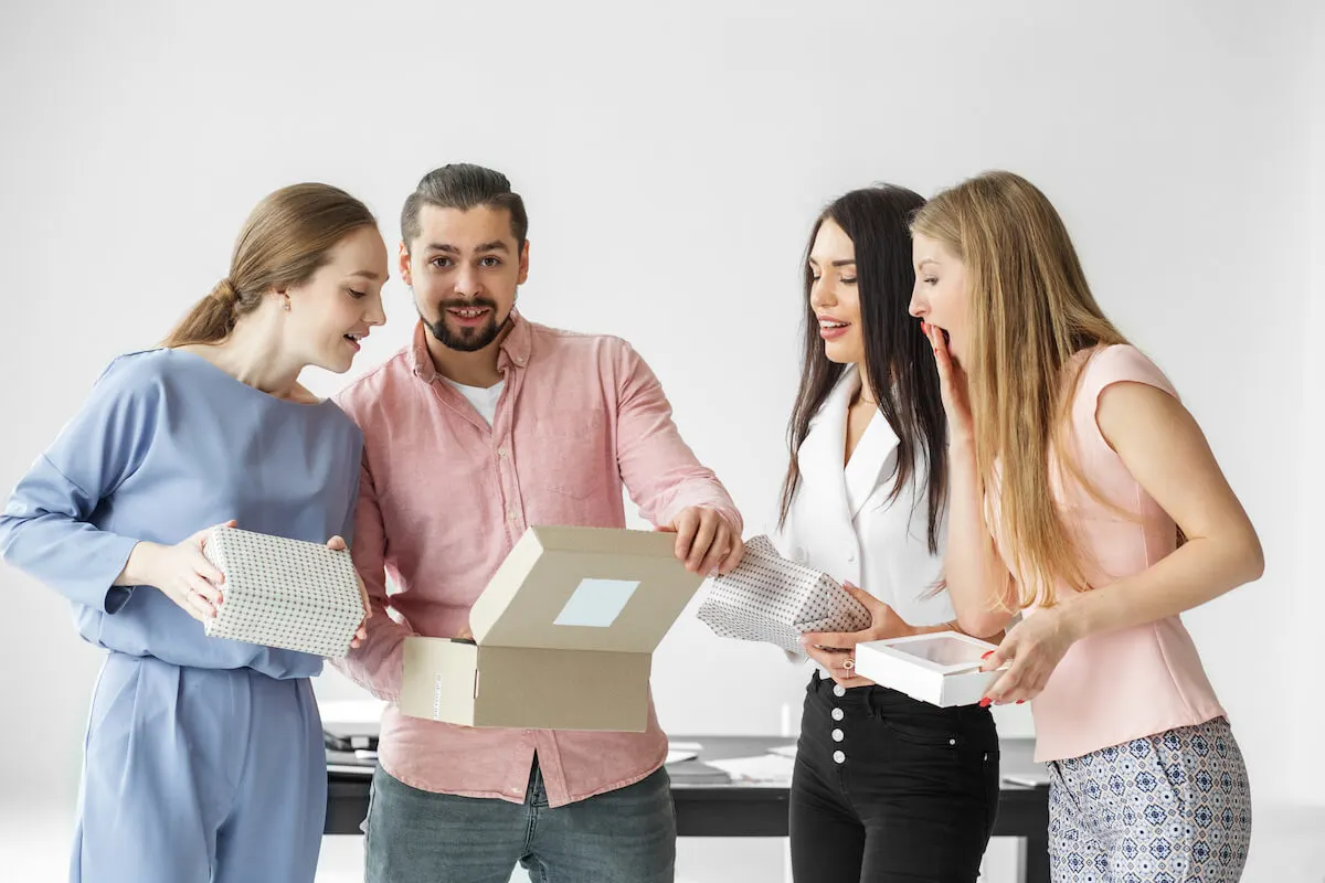 group of adults opening gifts together