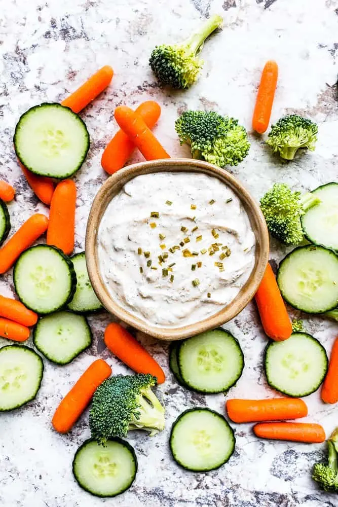 greek yogurt range dip surrounded by cut vegetables