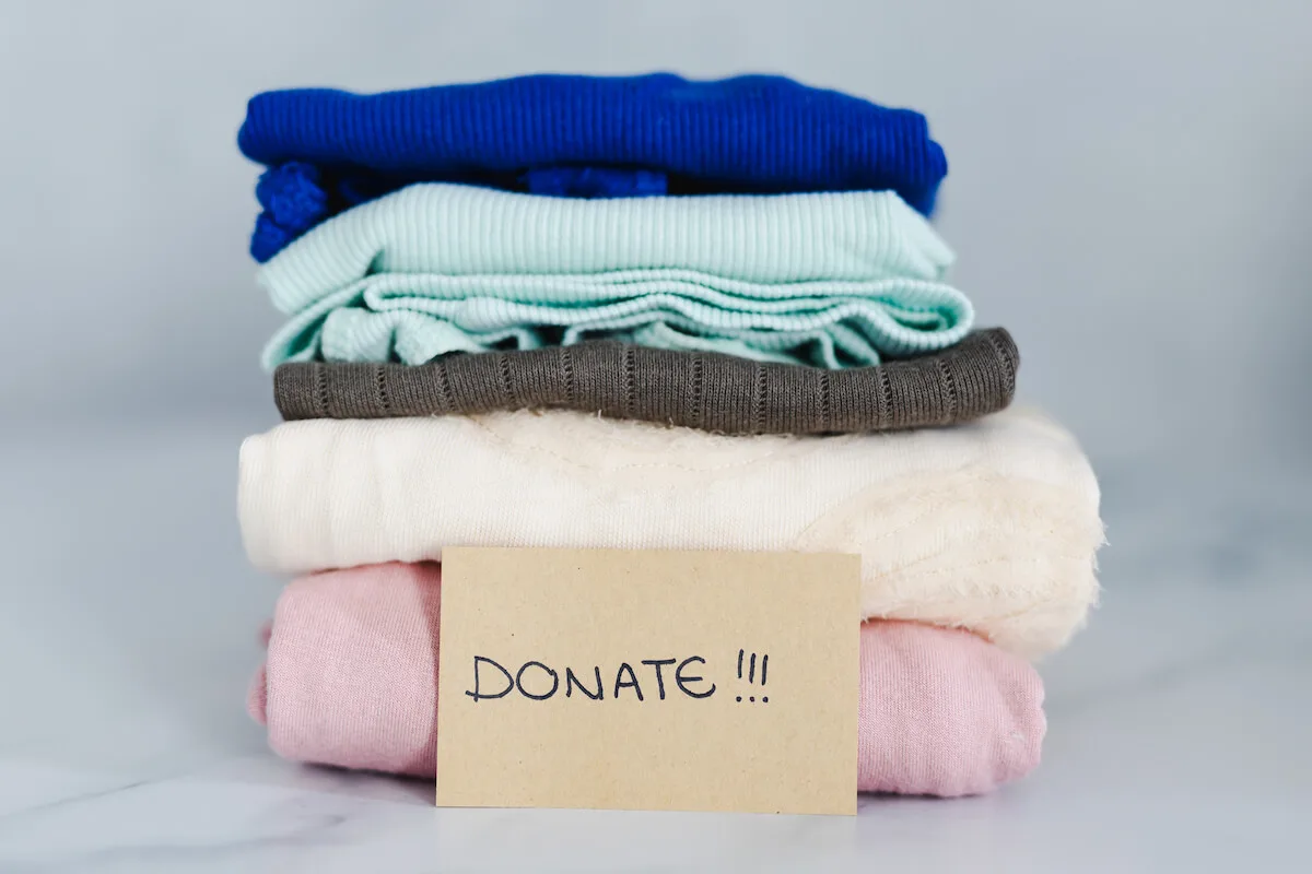 pile of folded clothing for donating