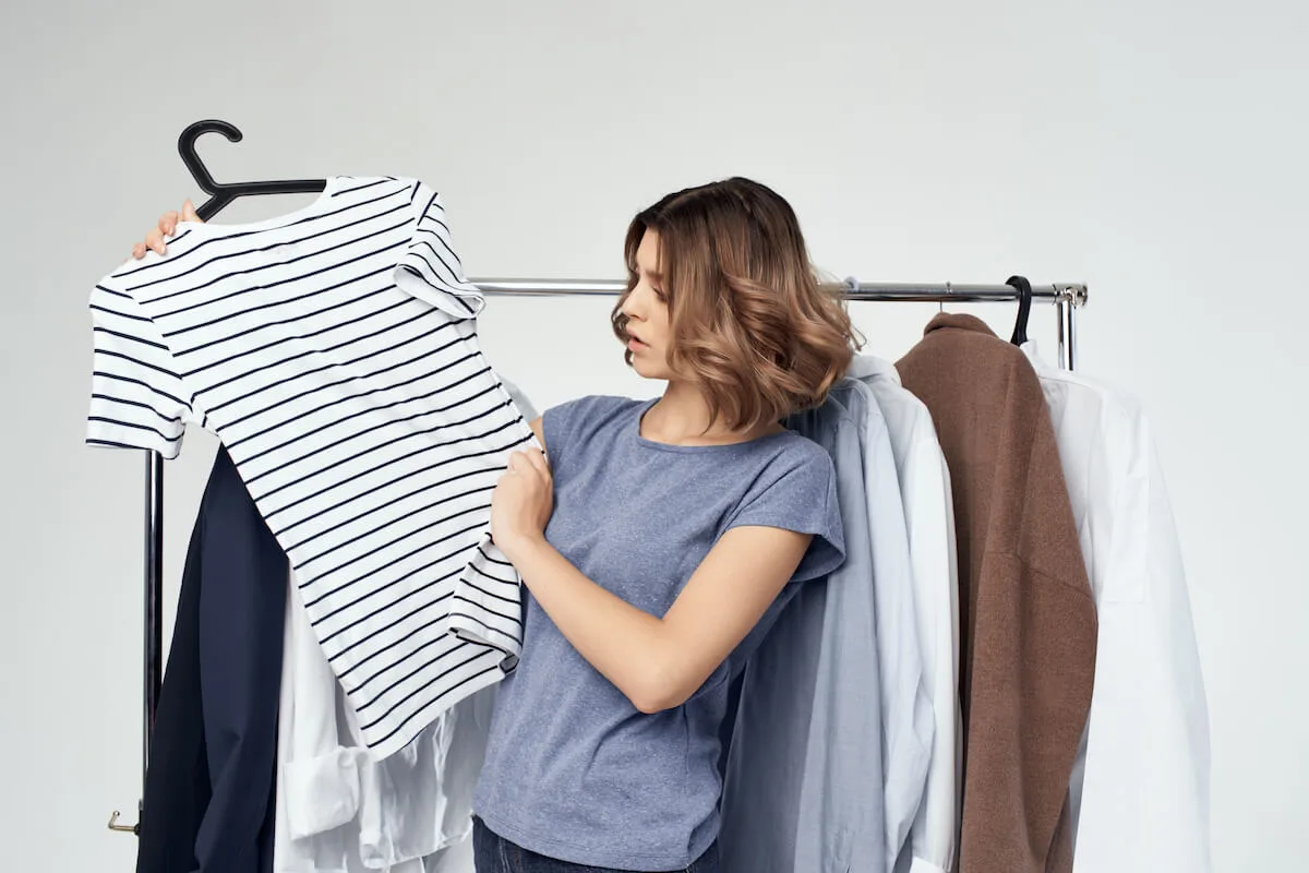 woman deciding if she wants to keep a shirt