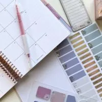 erin condren planner open on desk with planning accessories