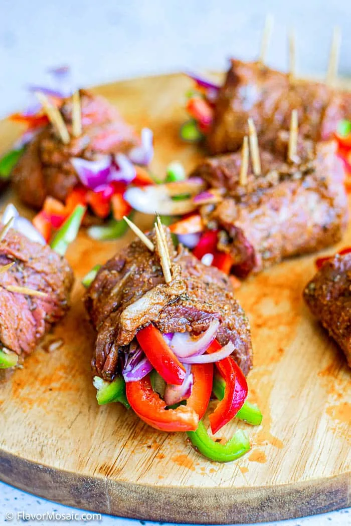 steak fajita roll ups on a serving board