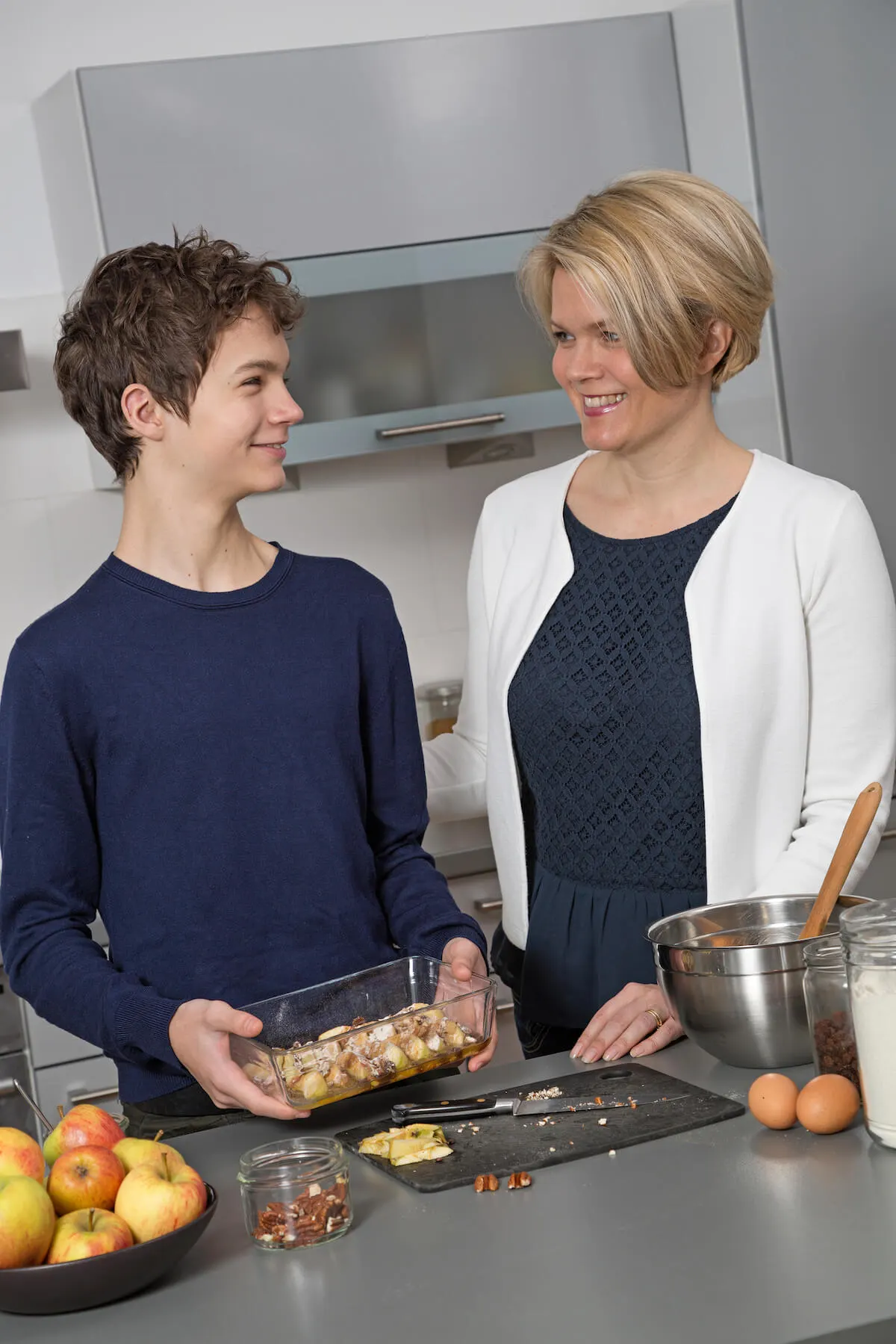 mother and son in kitchen preparing dinner together