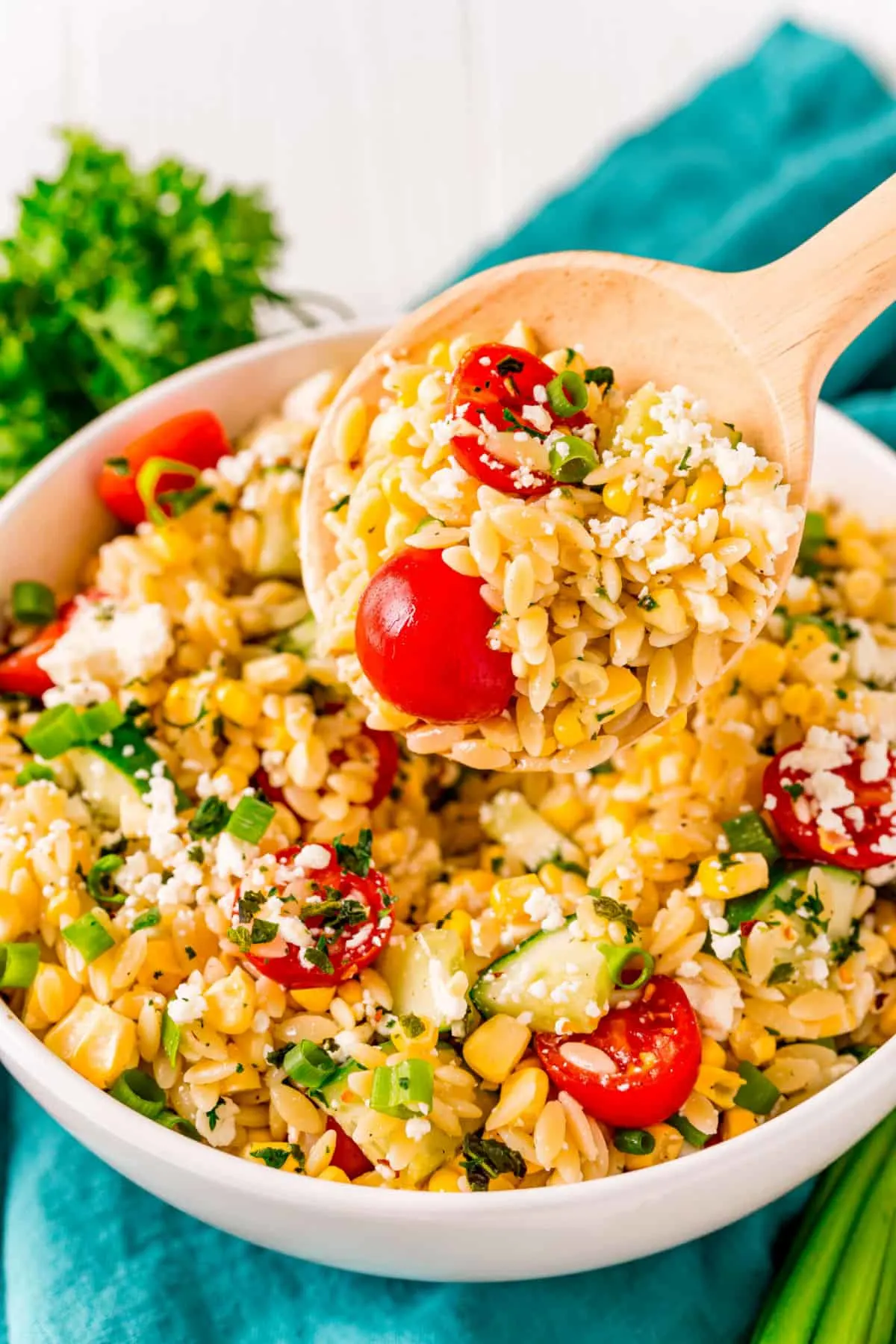 orzo pasta salad with serving spoon