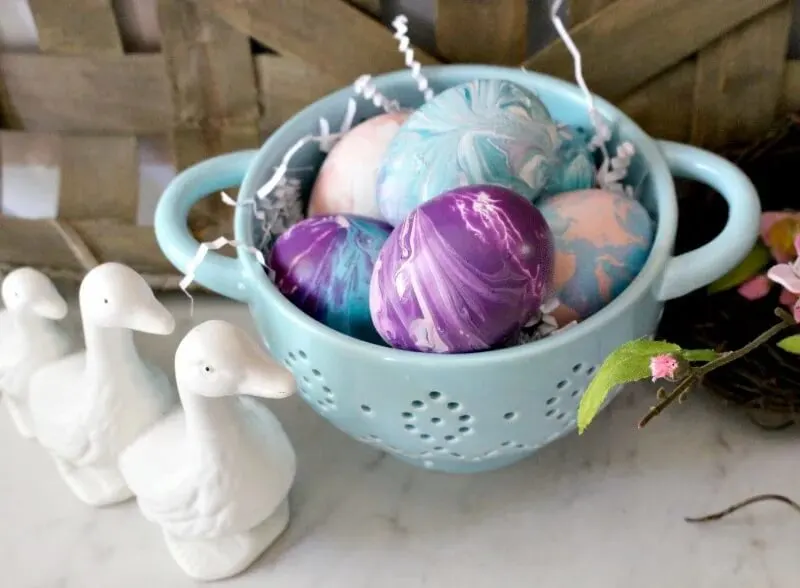 paint poured easter eggs in colander