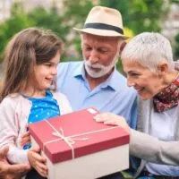 child giving grandparents a large gift